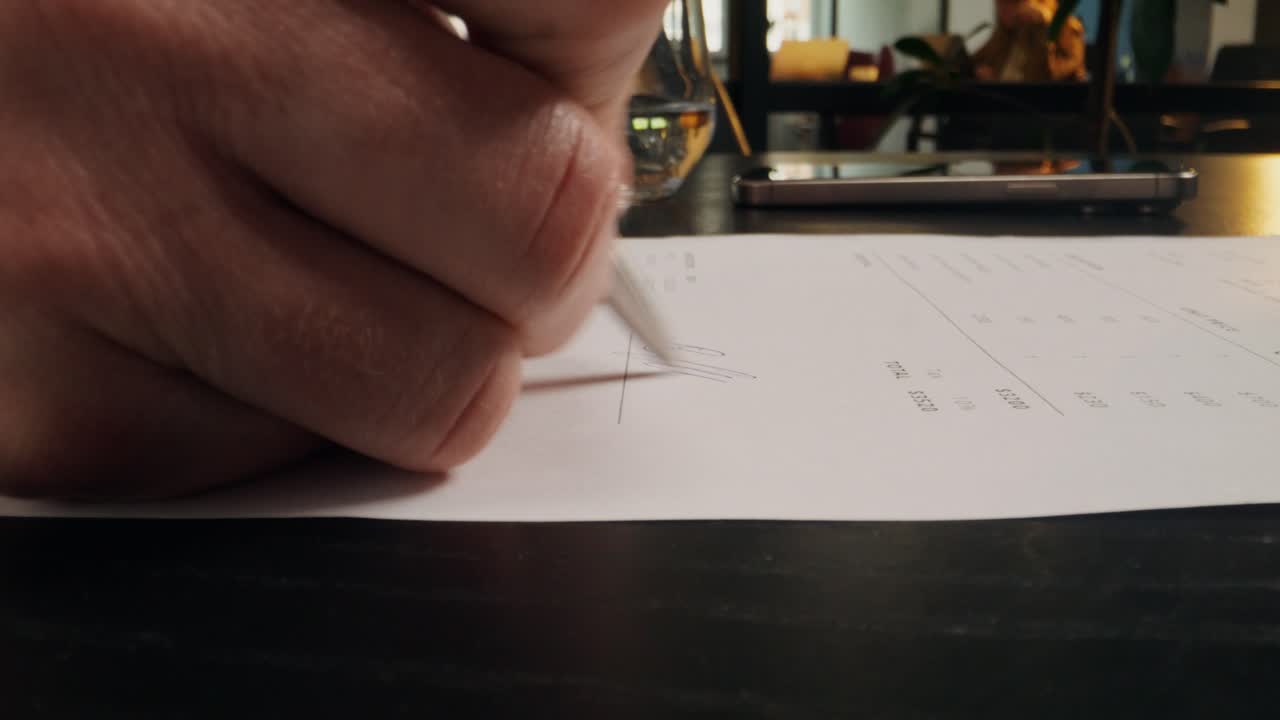 Signing a document in a cafe