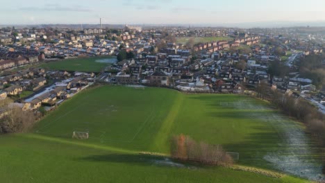 Drone's-eye-winter-view-captures-Dewsbury-Moore-Council-estate's-typical-UK-urban-council-owned-housing-development-with-red-brick-terraced-homes-and-the-industrial-Yorkshire