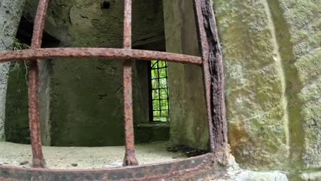 old medieval stone castle rusted iron bars covering open window for protection