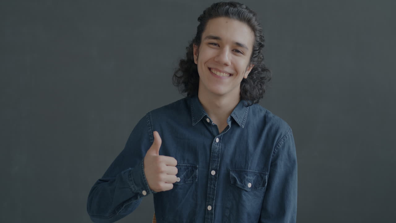 Happy Teenager Smiling and Giving a Thumbs Up