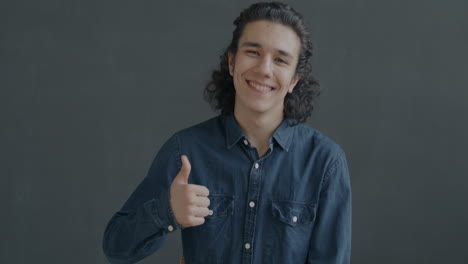 happy teenager smiling and giving a thumbs up