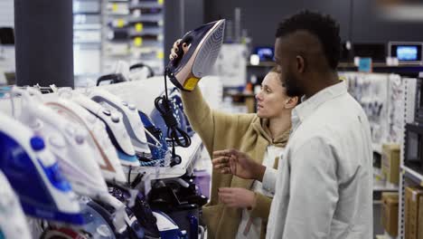 shot assistant helps the woman to choose and iron