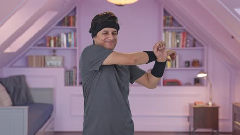 happy indian man doing arm stretching