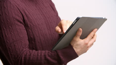 close up of man with digital tablet against white background