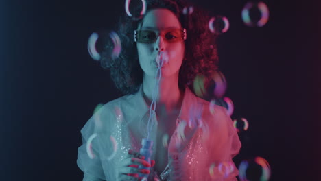 neon woman blowing bubbles