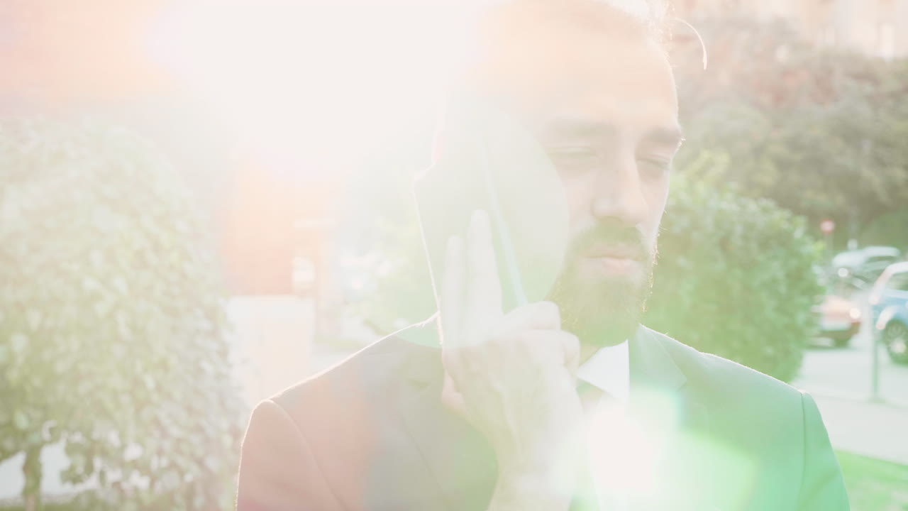 Man in suit talking on mobile phone outdoors