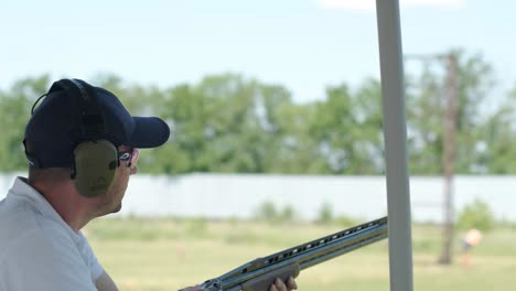 sportsman shoots from a double-barreled shotgun, a sports field for a shooting test is shooting at flying skeet