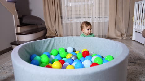 baby playing in a ball pit
