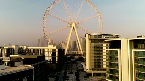 aerial view passing by of the ferris wheel under construction, dubai.