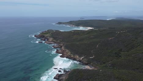 Aerial-,-shot-over-rocky-shore