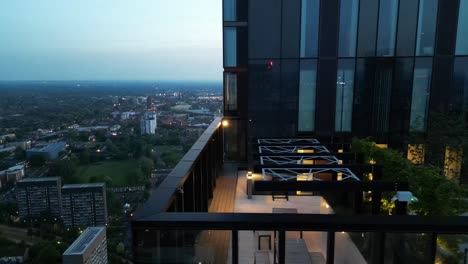 Aerial-drone-flight-passing-by-the-balcony-of-the-Victoria-Residence-Building-on-Deansgate-in-Manchester-City-Centre