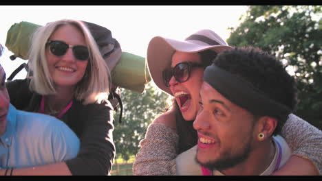 Slow-Motion-Shot-Of-Men-Giving-Women-Piggybacks-Outdoors