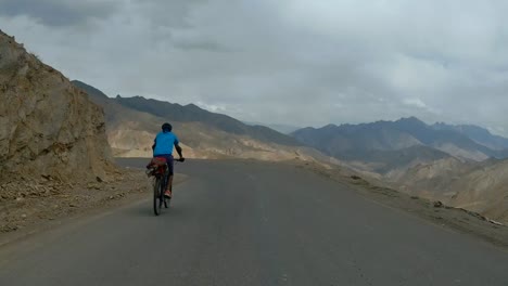 biker speeding on the mountain curssing road to leh in ladakh, india - rolling shot