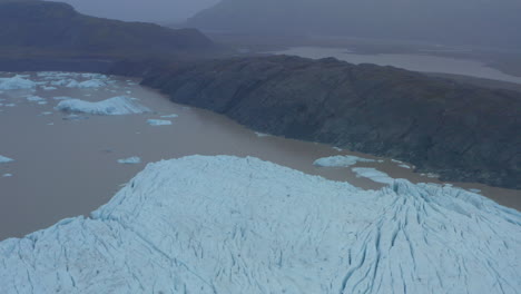 aerial slider shot over the edge of a large glacier