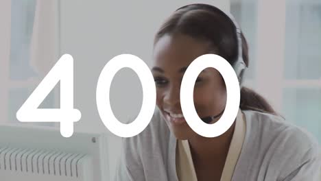 animation of numbers processing over mixed race smiling businesswoman wearing phone headset