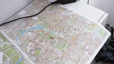 city map with markers and power adapter