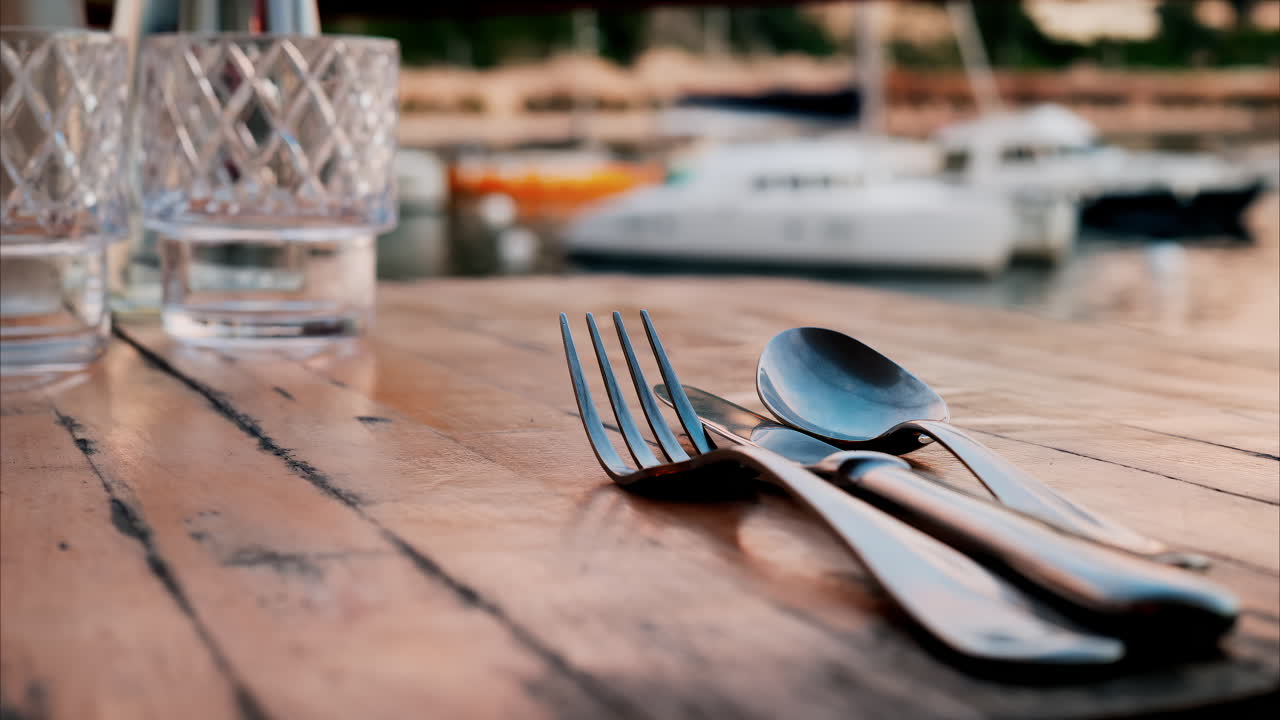 Close up view of a set table and the atmosphere at a restaurant near a port in the south of France