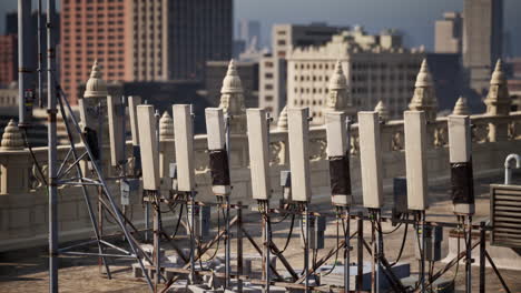 cell tower on a rooftop in a city