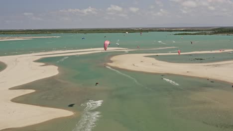 Kite-surfer-in-large-air-spin-trick-in-shallow-green-Brazil-bay-pond