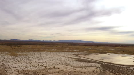 willcox playa, ancient lakebed covered in mud, drone shot flying forward