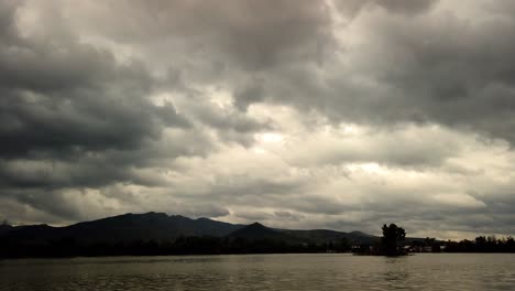 hyperlapse of clouds over mountain and lake