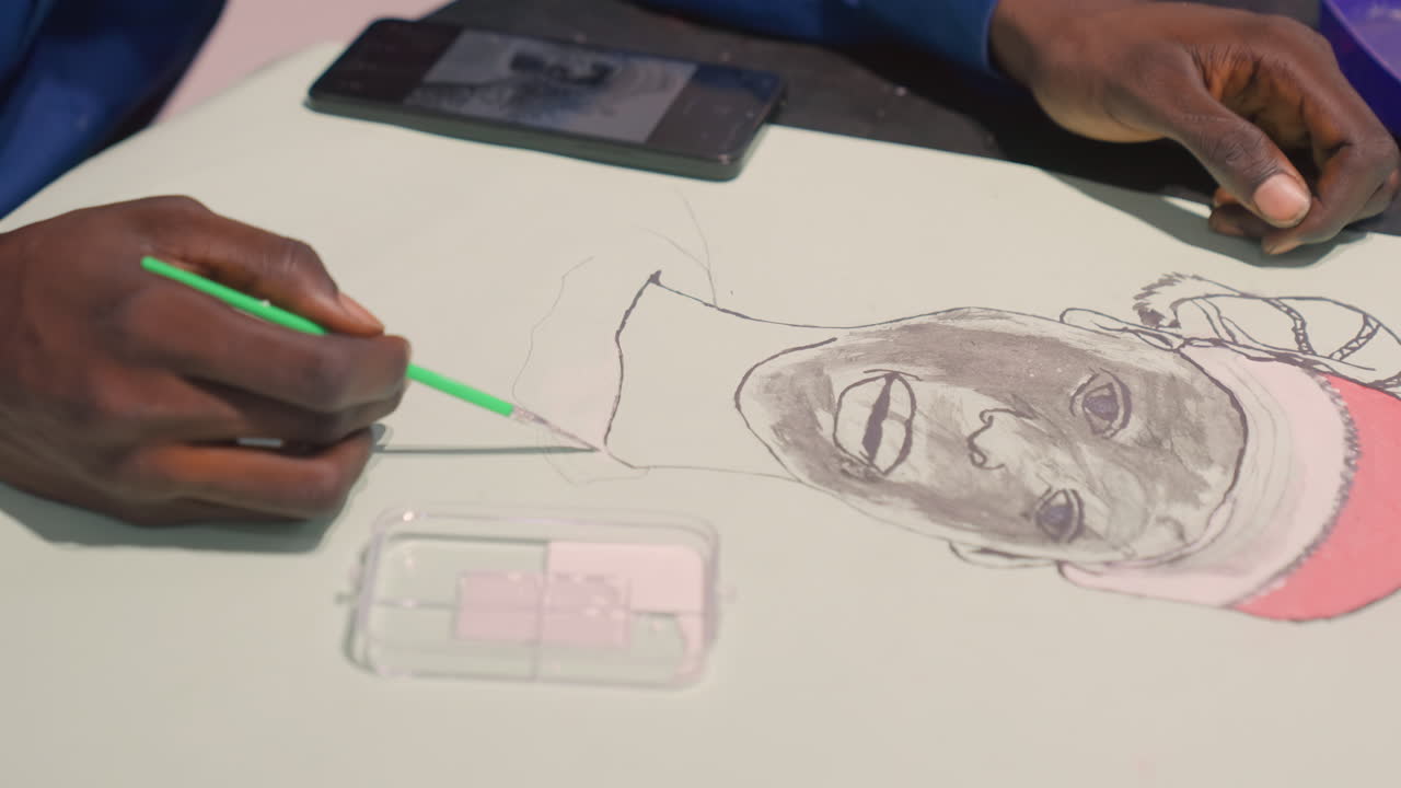 Black painting portrait showing studio technique, overhead shot of artist hand blending gray wash and pink highlights, tablet reference visible, focused illustrator practicing refined strokes, calm