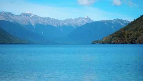 serene long shot of lake rotoroa, framed by majestic mountains