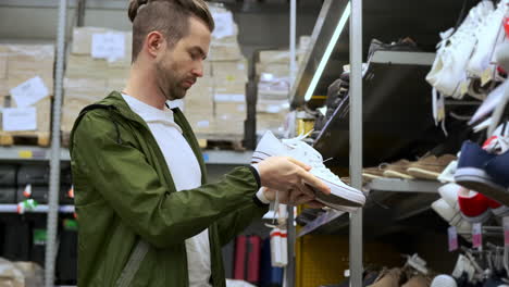 man shopping for sneakers in a shoe store