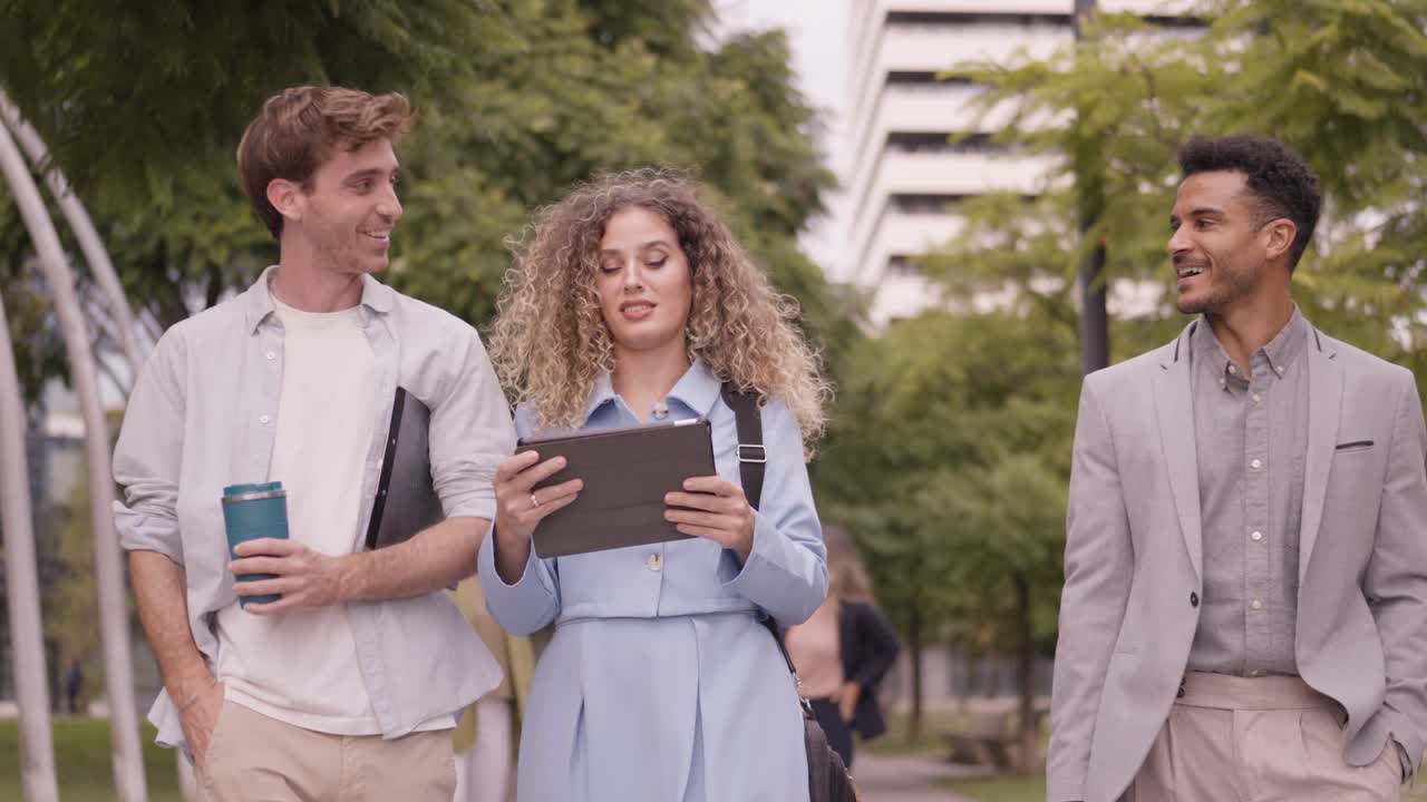 Business professionals walking and talking outdoors