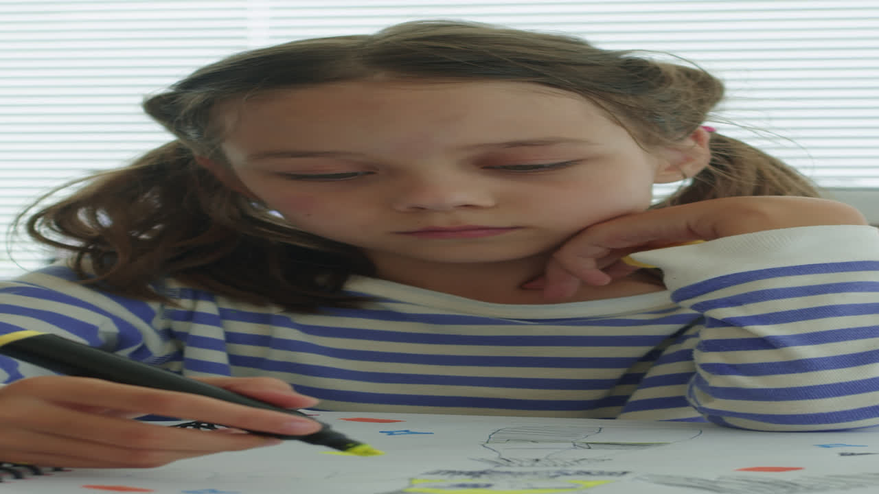 Schoolgirl Drawing in Notebook and Smiling at Camera at Desk