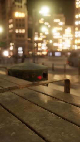 nighttime street scene with a bench and people walking