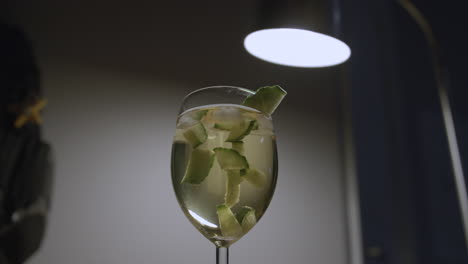 cucumber chunks float gently in a glass of sangria