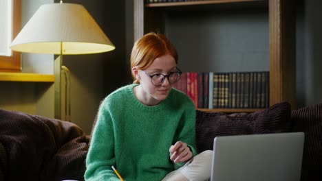 teenage girl having an online class at home