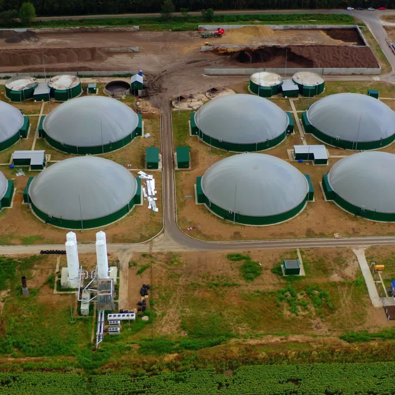 Innovative bio gas agriculture. Modern farm for biogas production from organic biomass. Biogas plant construction on field. Top aerial view.