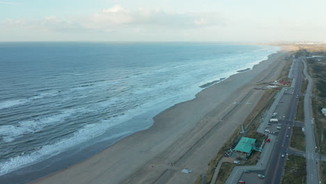 waves crashing in the sandy beach of zandvoort in the netherlands - aerial shot
