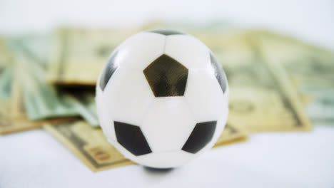 Football-and-dollar-against-white-background-4k