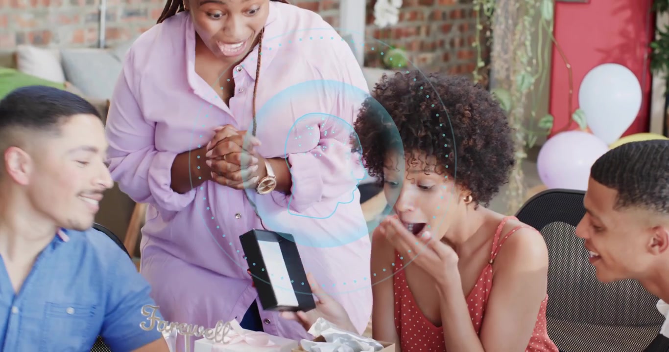 seated woman receiving gift box from adult friend and unwrapping nested box for birthday surprise