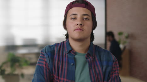 portrait of casual young caucasian man in office workspace arms crossed looking serious confident at camera successful start up business