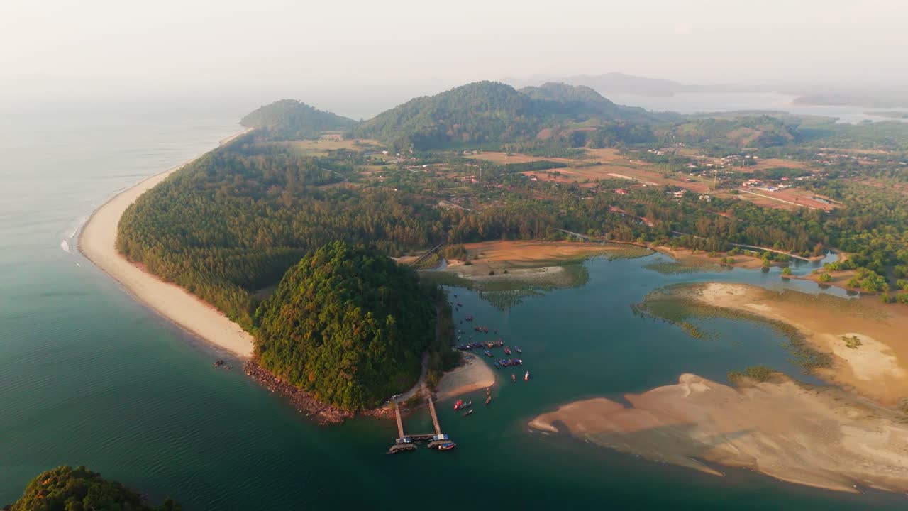 Lush coastline and tropical peninsula surrounded by blue sea in Laem Son National Park, Thailand, aerial