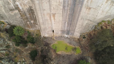 aerial: drone tilt up of water dam