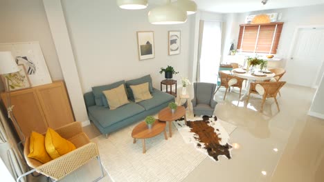 stylish and cosy living room, furnished with armchair, couch, pillows