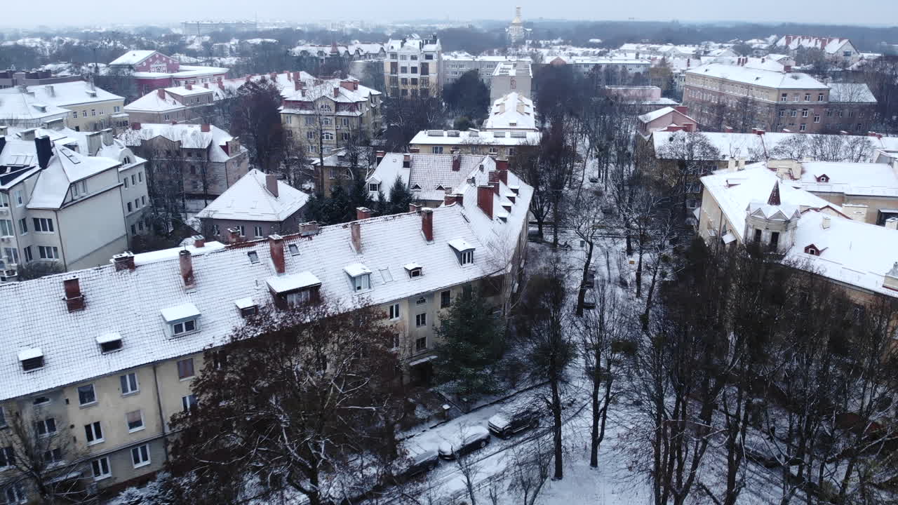 Snowy Urban Landscape with Buildings and Trees