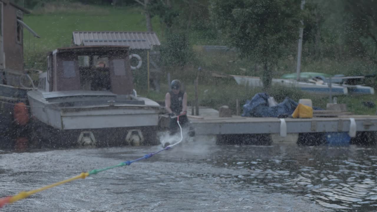 Slalom skier jump starts pulled off dock water skiing