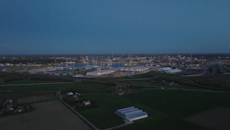 aerial view of the industrial and port area of ravenna ,chemical and petrochemical pole,thermoelectric,metallurgical plants and hydrocarbon refinery and liquefied natural gas tanks at night