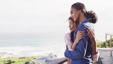 Video-of-happy-diverse-female-friends-embracing-at-sea