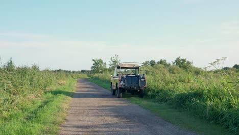 classic land rover on a country road