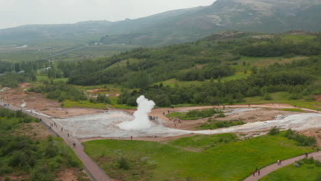 Birds-eye-of-Strokkur-geyser,-most-famous-attraction-of-golden-circle,-erupting.-Top-view-of-powerful-eruption-of-geyser,-hot-steaming-crater-in-Geysir-valley.-Touristic-destination