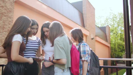 las adolescentes se divierten y conversan usando sus teléfonos móviles