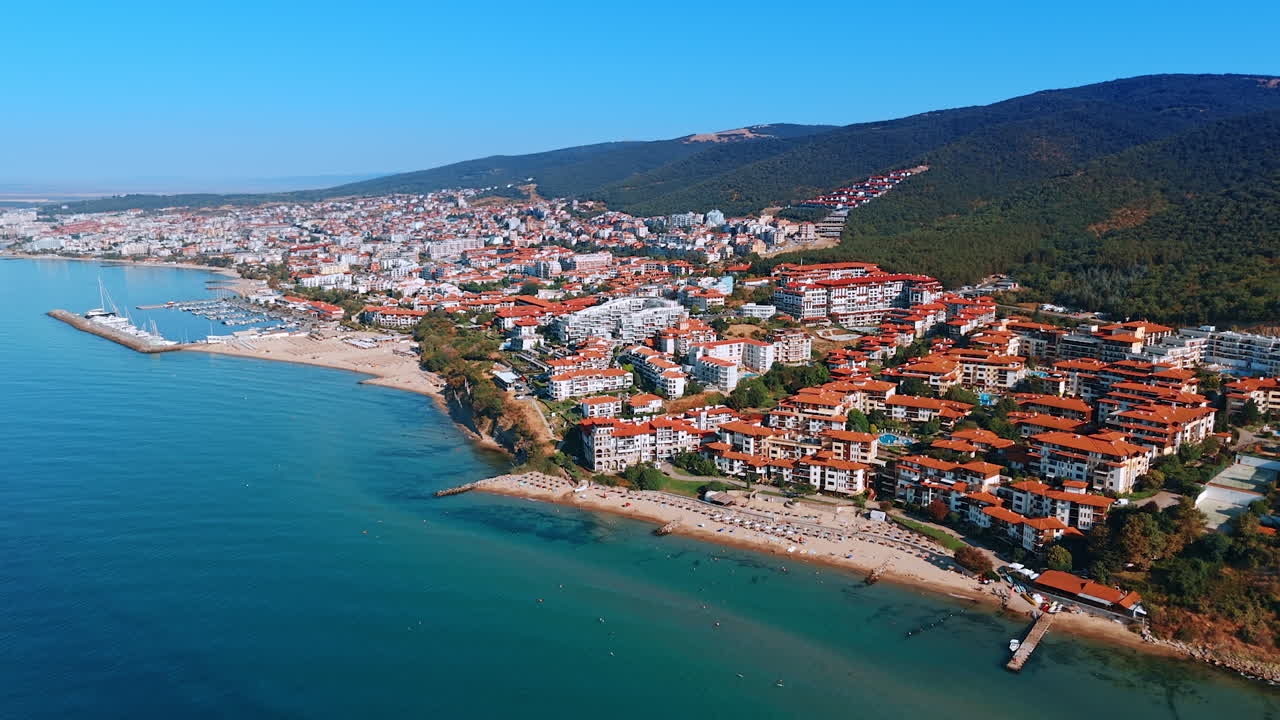 Orange roofs of the multiple hotels located on the coast of the Black Sea. Beautiful resort city Sveti Vlas in Bulgaria on sunny summer day