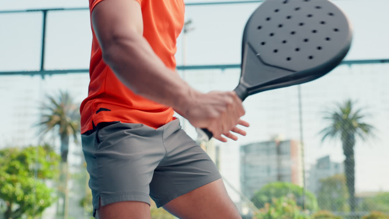 Close-up of Man Practicing Padel Racket Swings on Court